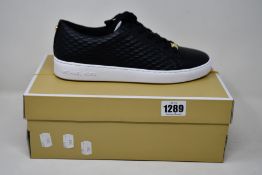 A pair of as new Michael Kors Keaton lace up sneakers (US 9M).