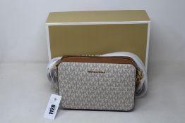 An as new Michael Kors Jet Set camera bag.