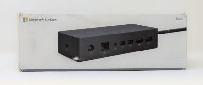 A boxed as new Microsoft Surface Dock (P/N: PF3-00012) (Box sealed, some damage to box).