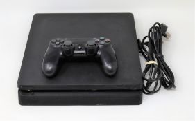 A pre-owned Sony PlayStation 4 500GB games console in black. One controller and HDMI/power cables su