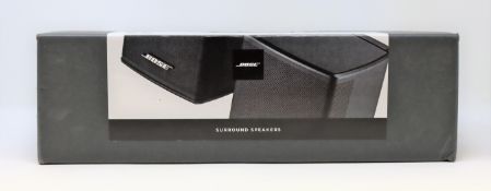 A pre-owned pair of Bose Surround Sound Speakers in Black (Small dent to one speaker grille, Unteste