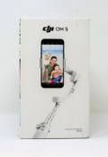 A boxed as new DJI OM 5 Smartphone Gimbal in Athens Grey (Box sealed).