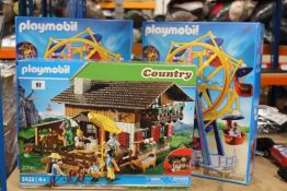 Two as new Playmobil 5552 Ferris Wheel with lights play sets and an as new 5422 Alpine Lodge play