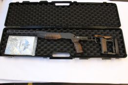 An Akila Chasis System for Blaser R8 with a walnut finish and a hard carry case.