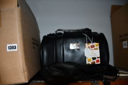 An as new Nova Harley Manhattan blackberry leather changing bag.