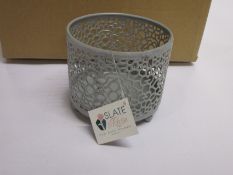 Forty two Marrakesh Antique White Moroccan style cut out tea light holders and three Mosaic tea