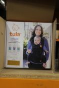 A boxed as new Tula Explore multi-position baby and toddler carrier.