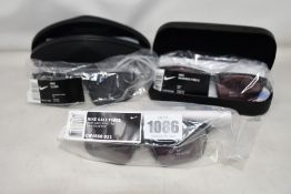 Three pairs of assorted as new Nike sunglasses.