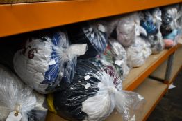 Eleven bags of pre-owned clothing and related items.