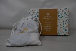 Forty boxed Grace and Evergreen washable and reusable makeup remover pads.