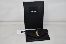 An as new Saint Laurent zipped card case with pouch in black leather.