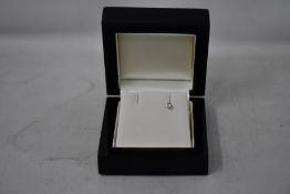 A single diamond stud earring.