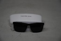 A pair of as new Calvin Klein sunglasses.