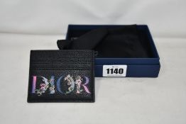 An as new Dior Flowers card holder with box.