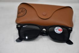 A pair of as new Ray Ban sunglasses.