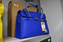 An as new Nova Harley Luxury Elegant Blue leather changing bag.
