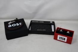 An as new Michael Kors Tall card case, Hugo Boss cufflinks and Hugo Boss double wrap braided leather