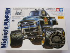 A boxed as new Tamiya Midnight Pumpkin 1/12th Scale R/C Classic 1950's Style Pick Up Truck.