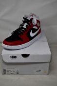A pair of women's as new Nike Air Jordan 1 Mid with authentication tag (UK9).
