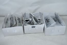 Three boxes of unbranded sunglasses.