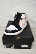 A pair of as new Nike Air Jordan 1 Mid with authentication tag (UK 10).