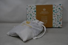 Forty boxed Grace and Evergreen washable and reusable makeup remover pads.