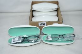 Six pairs of as new Cocoa Mint glasses frames with cases.