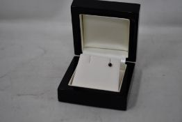 A single sapphire stud earring.