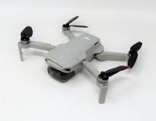 A pre-owned DJI Mavic Mini 2 Drone (Damage to body. Untested, sold as seen).