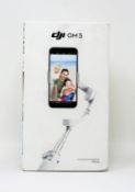 A boxed as new DJI OM 5 Smartphone Gimbal in Athens Grey (Box sealed).