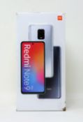 A boxed as new Redmi Note 9 Pro 64GB in Tropical Green (Box sealed, some damage to box) (Checkmend r