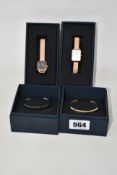 Two women's Daniel Wellington watches and two bangles.