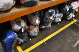 Twelve bags of assorted clothing and related items.