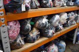 Thirteen bags of assorted clothing and related items.