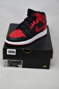 A pair of youths as new Nike Air Jordan 1 Mid (UK 3.5).