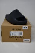 A pair of as new Yeezy Slide with authentication tag (UK 10).