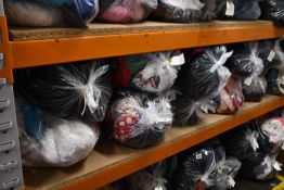 Twelve bags of assorted clothing and related items.