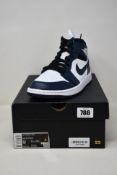 A pair of as new Nike Air Jordan 1 Mid with authentication tag (UK 8).