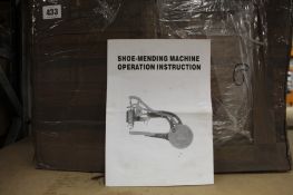 An unbranded shoe-mending machine.