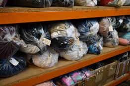 Thirteen bags of assorted clothing and related items.