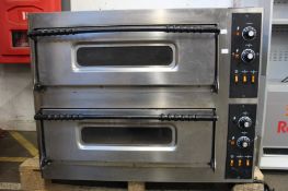 A large pre-owned commercial double deck pizza oven.