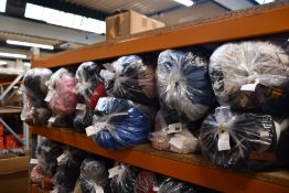 Twelve bags of assorted clothing and related items.