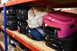Seven suitcases/holdalls, some containing assorted clothing and related items, some suitcases are
