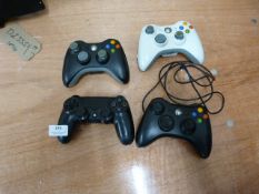 One PlayStation and Three Xbox Controllers