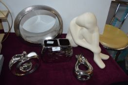 Four Metallic Ornaments and a Seated Figure