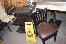 *Black Three Tier Trolley, Cleaning Sign, and a Si