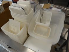 * selection of plastic containers, whisk and chopping board