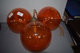 Three Orange Glass Globe Pendant Lights
