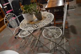 *Folding Steel Bistro Table and Two Chairs with Two Potted Plants