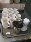 * selection of mugs, tea spoons and coffee machine cleaning